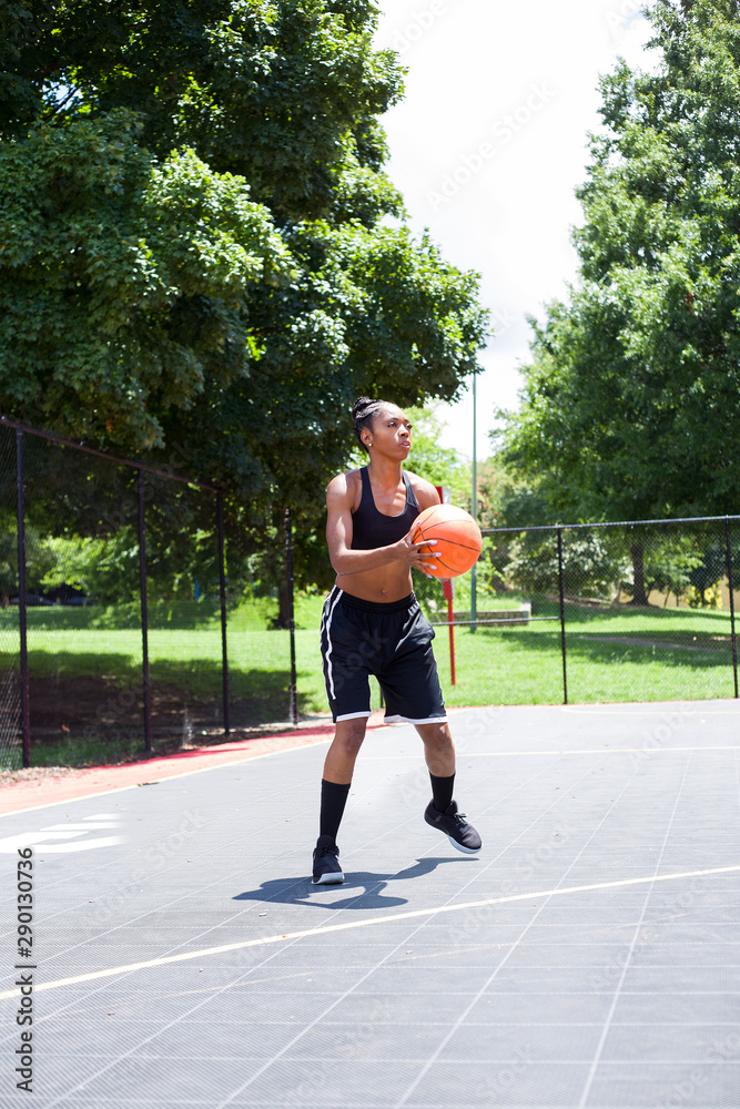 Woman in black playing basketball Woman in black playing basketball