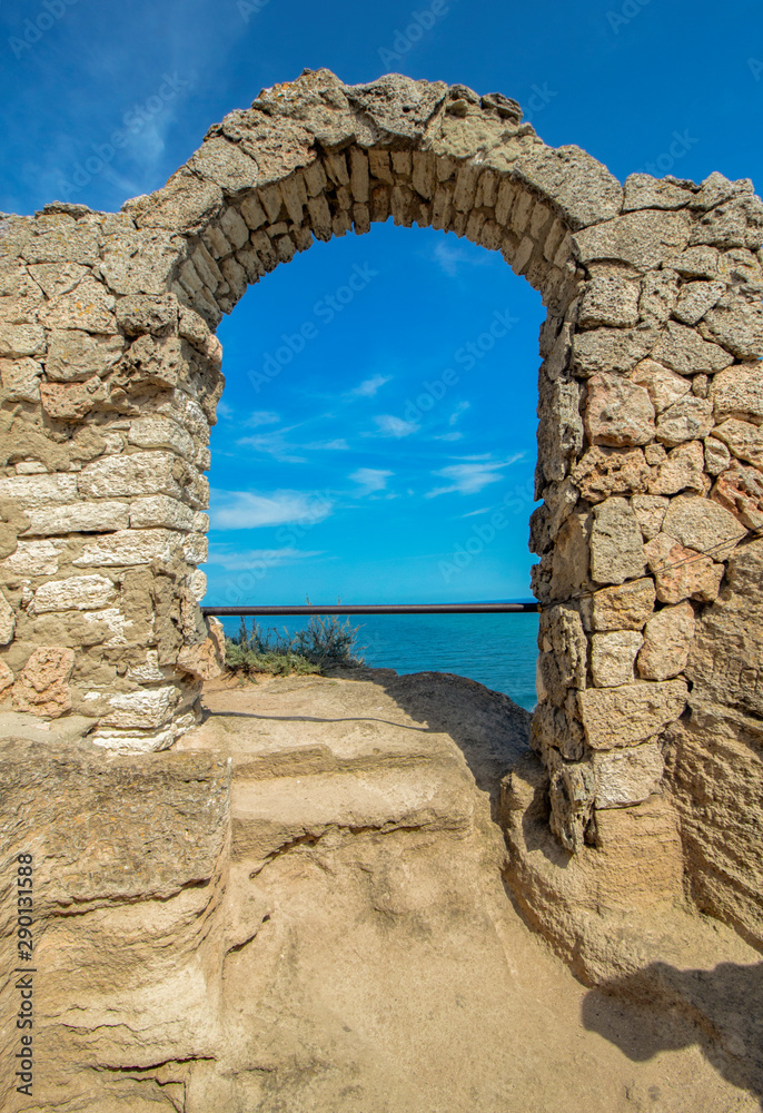 The arch of the ancient fortress of Cape Kaliakra above the sea against the background of the azure sky. Northern Black Sea Coast, Bulgaria.