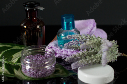 Fototapeta Naklejka Na Ścianę i Meble -  Aromatherapy and Spa treatments. Bottles and a bouquet of laundy.