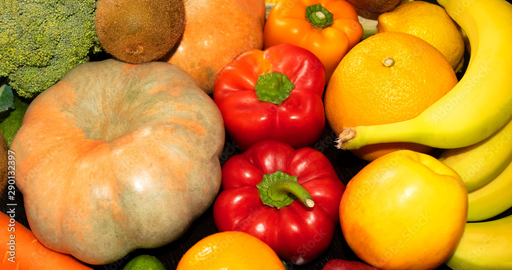 Assortment of fresh fruits and vegetables such as pumpkin, capsicum, broccoli, carrot, orange, lemon, banana, apple. 