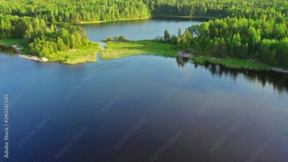 Green island in blue lake aerial view. The Ladoga Skerries National Park Green island in blue lake aerial view. The Ladoga Skerries National Park