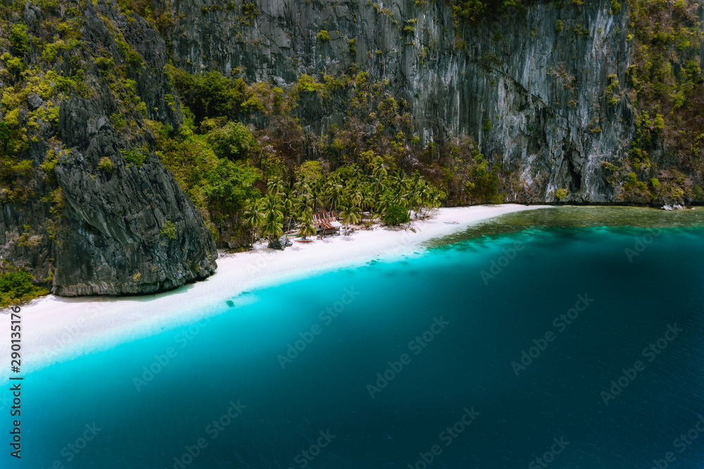 El Nido, Palawan, Philippines. Aerial drone view of solitude tropical hut on Pinagbuyutan Island. Amazing white sand beach with turquoise blue lagoon water