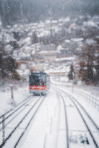 Defocused window view of funicular traveling through snowy scenery © YesPhotographers