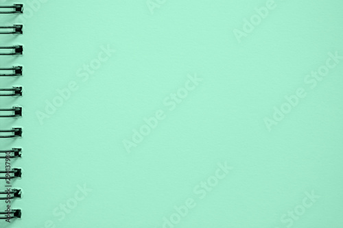 Texture of paper for artwork, notebook, on spiral for sketches, light green mint color. Copy space, background use