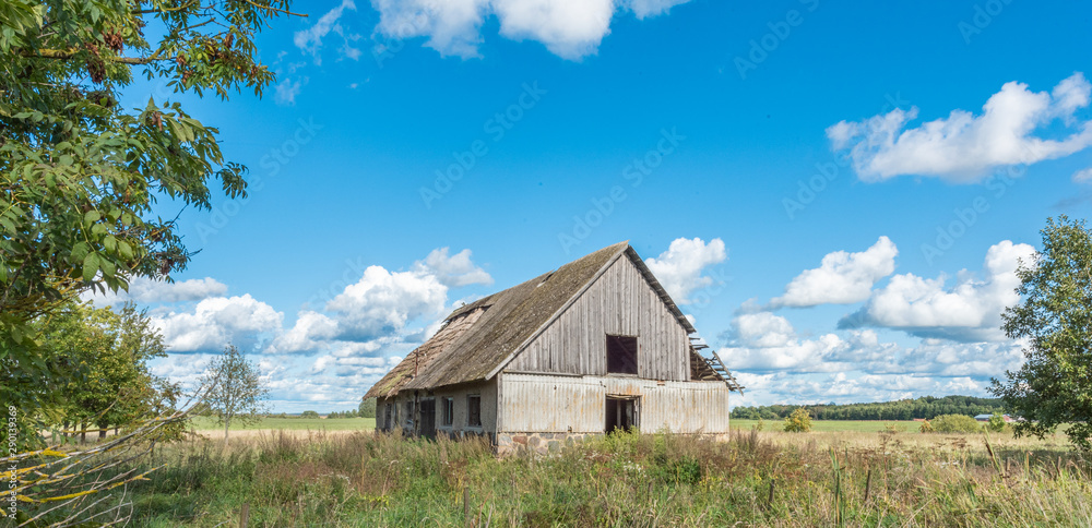old wooden house in field