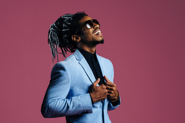 Portrait of a man with cool hair and sunglasses looking up