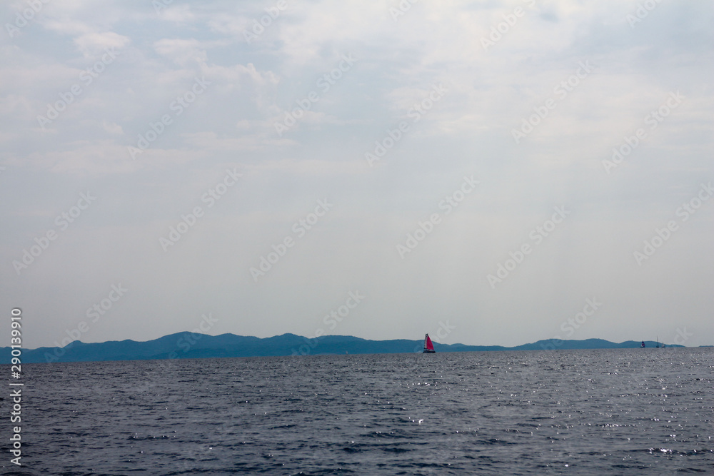 red sailboat on the sea