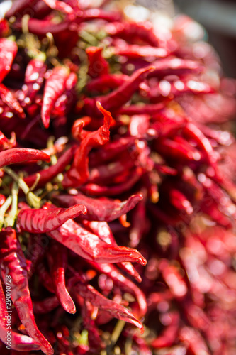 Dried red chilli paprika on a market stall with out of focus areas on the right. © Ferenc