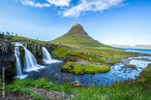 Kirkjufellsfoss, the most photographed mountain in Iceland, a long exposure and tourists visiting it