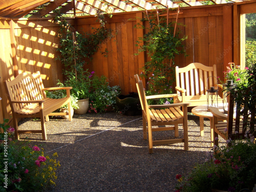 Fototapeta premium Chairs, Table, Benches on Patio at Sunset