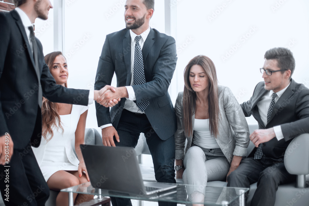 businessmen greet each other with a handshake