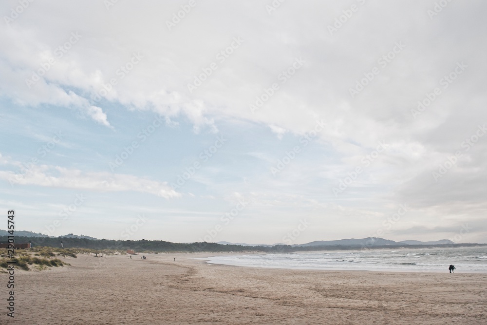 Beach landscape with a silhouette couple. Nazaré, Portugal