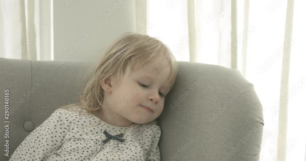 Little baby girl sitting in armchair in home. Childhood concept. Copy space. Little baby girl sitting in armchair in home. Childhood concept. Copy space.
