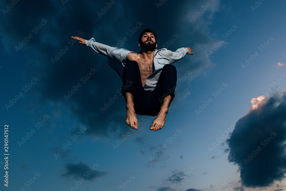 Freedom,handsome man jumping high in the sky while dancing