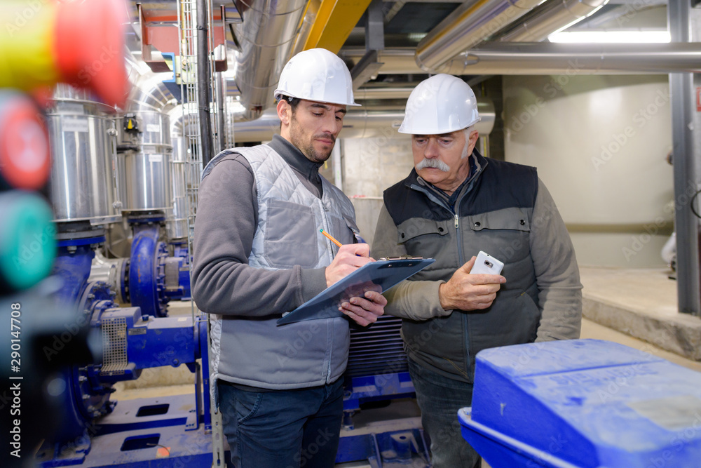two engineer working in the boiler room two engineer working in the boiler room