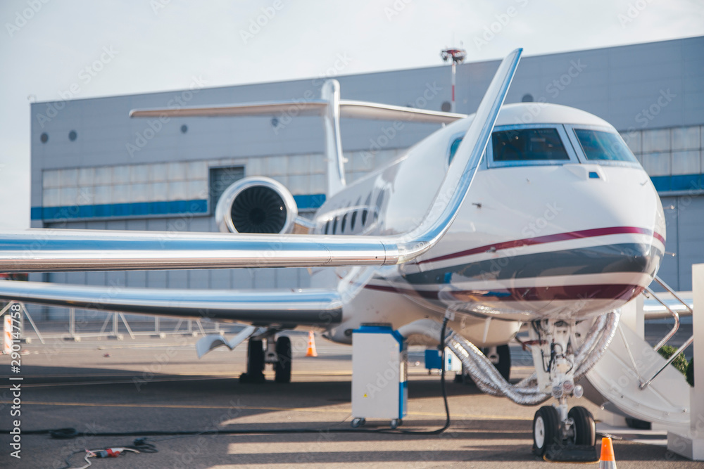 modern and comfortable business jet plane in the afternoon at the airport modern and comfortable business jet plane in the afternoon at the airport