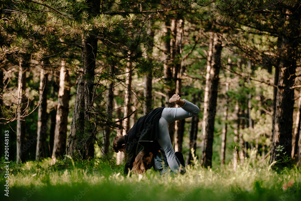 Carefree man in the woods practicing with an attractive colleague