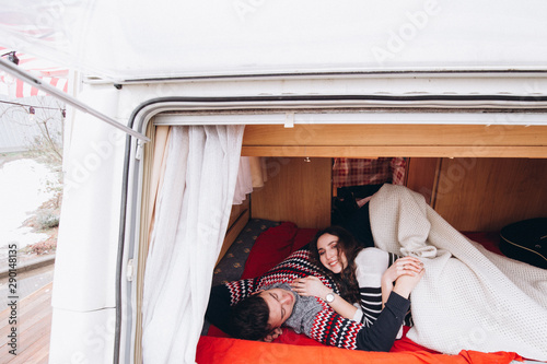 Loving couple alone in a trailer on a trip. Romance for lovers.
