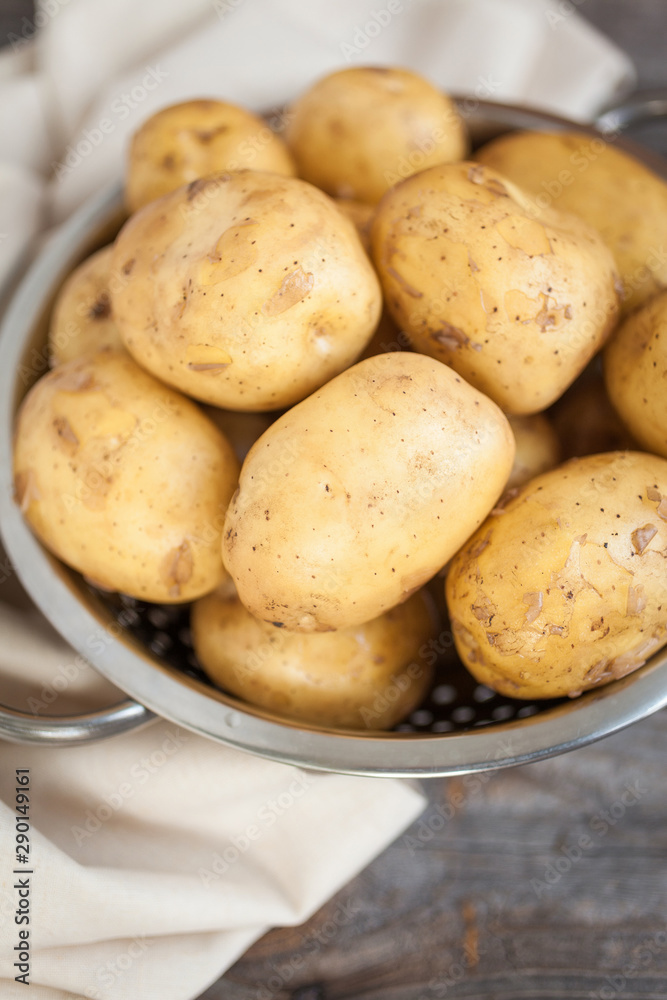 Raw potato. Fresh new potatoes on wooden background Raw potato. Fresh new potatoes on wooden background