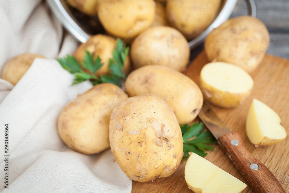 Raw potato. Fresh new potatoes on wooden background