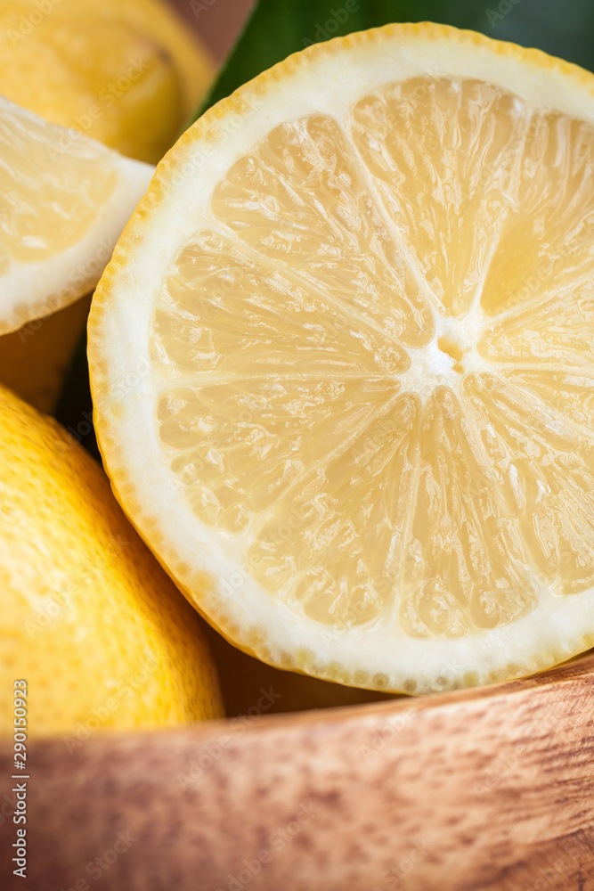 Juicy ripe citrus on old wooden background. Fresh lemons in a bowl Juicy ripe citrus on old wooden background. Fresh lemons in a bowl