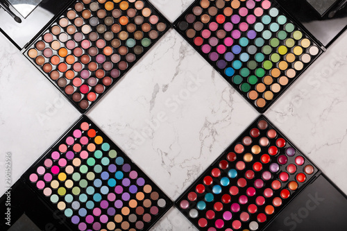 Wallpaper Mural Flat lay of cosmetic eyeshadow palettes on white marble background. Top view Torontodigital.ca