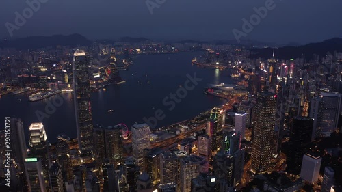 Wallpaper Mural Bird eyes view of Hong Kong cityscape from the drone at night time. Tight aerial forward shot flying over office buildings and skyscrapers. Torontodigital.ca