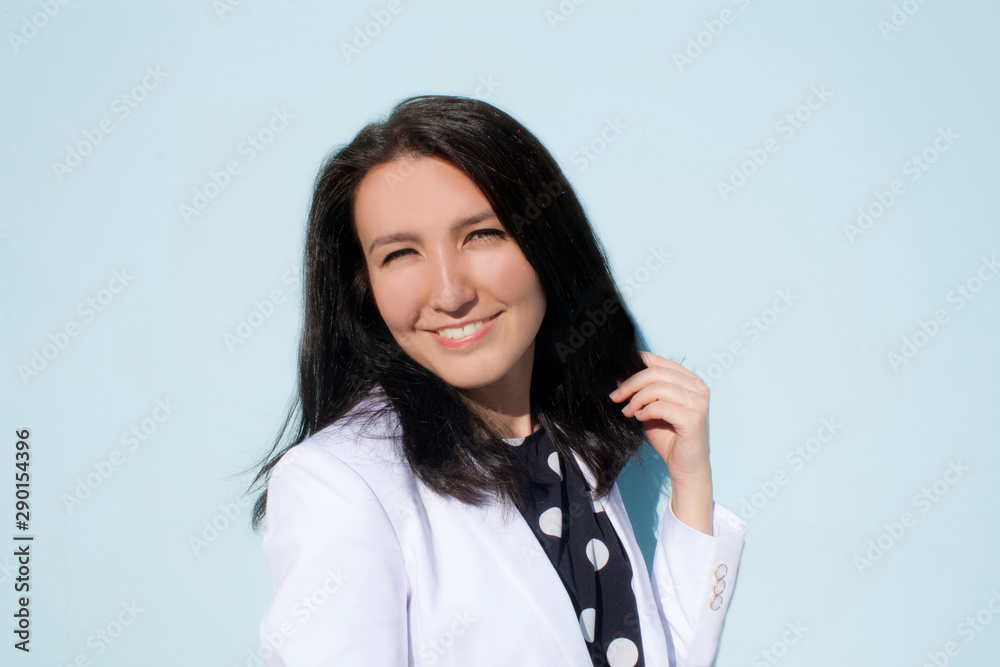 Prtrait of woman with white smile and white jaket, black hair and asian or european style, pretty model face for advertisment Prtrait of woman with white smile and white jaket, black hair and asian or european style, pretty model face for advertisment