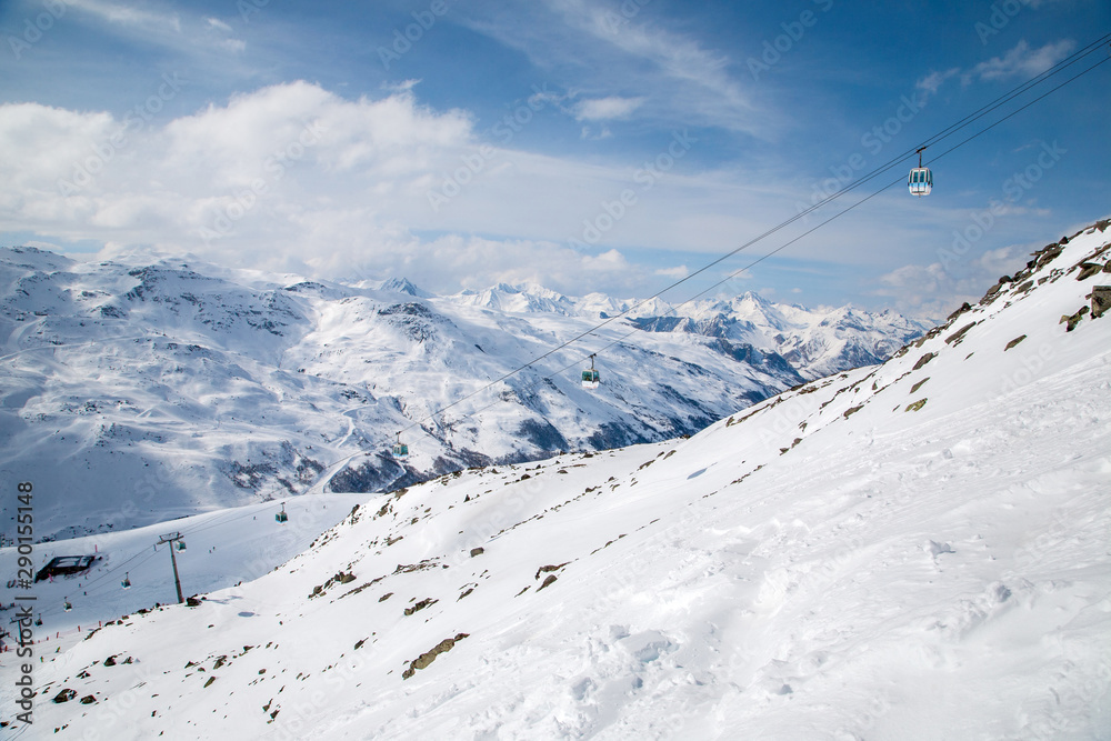 Panoramic view of ski resort three valleys and big lift in french alps - Vacation and travel concept - Winter high season opening with people having fun on mountain - Focus on sport equipment
