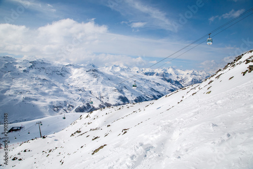 Panoramic view of ski resort three valleys and big lift in french alps - Vacation and travel concept - Winter high season opening with people having fun on mountain - Focus on sport equipment