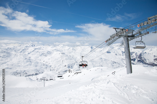 Panoramic view of ski resort three valleys and big lift in french alps - Vacation and travel concept - Winter high season opening with people having fun on mountain - Focus on sport equipment © Dmitry Melnik