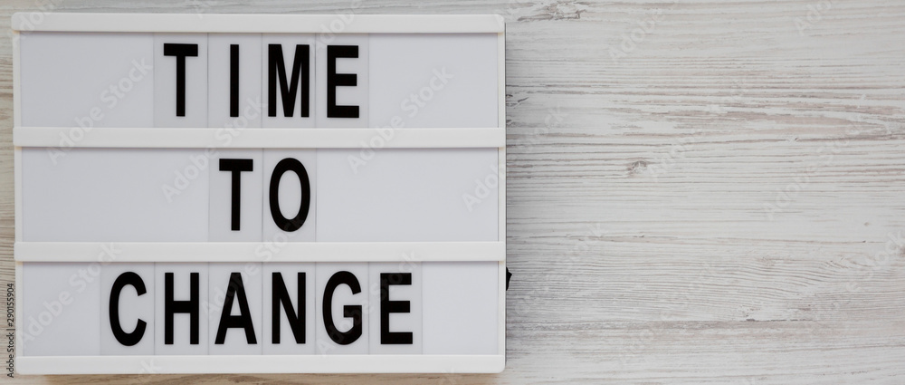 'Time to change' words on a modern board on a white wooden background, top view. Overhead, from above. Flat lay. Copy space. 'Time to change' words on a modern board on a white wooden background, top view. Overhead, from above. Flat lay. Copy space.