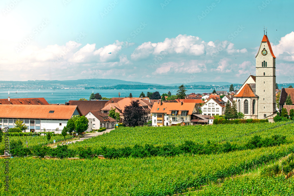 Panoramic view of lake of Lake Constance. Zeppelin and Catholic Church St. Johann Baptist in Hagnau on the picture.