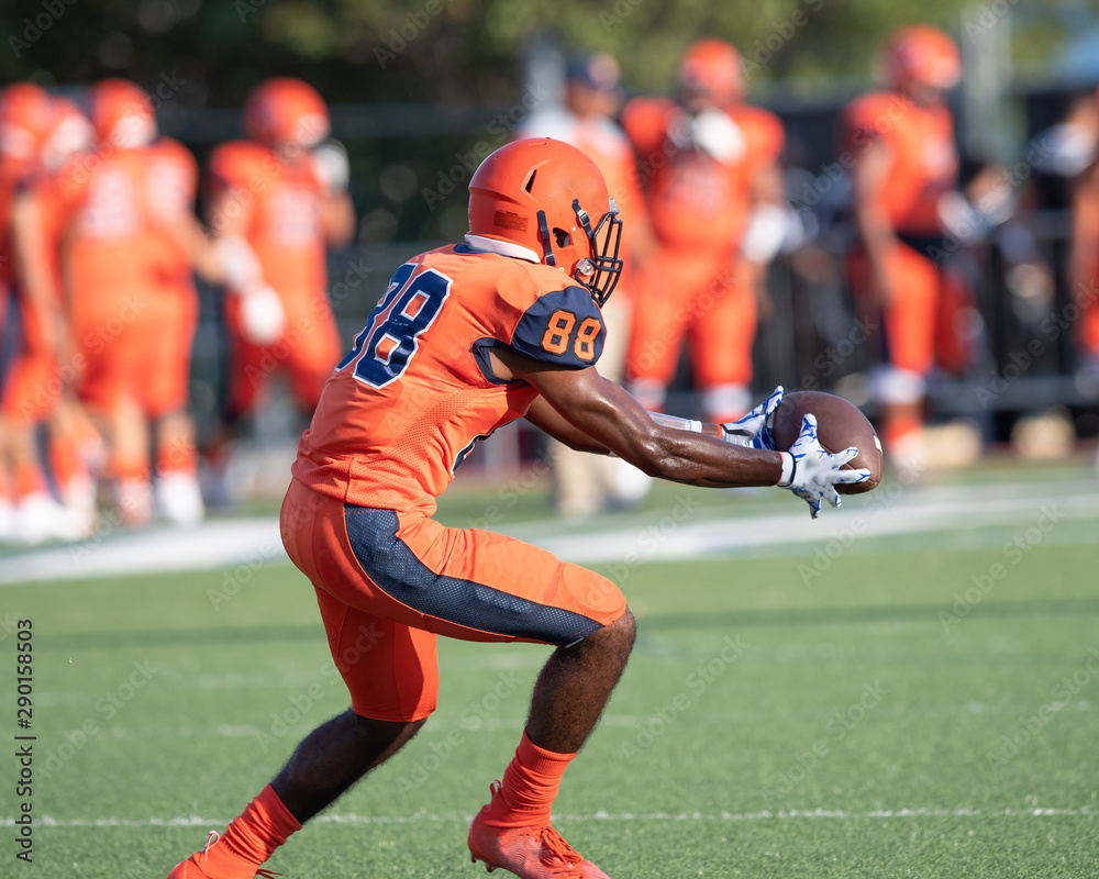 Fototapeta premium Great action photos of high school football players making amazing plays during a football game