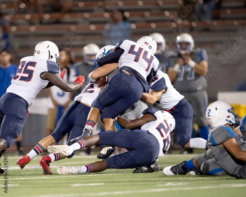 Great action photos of high school football players making amazing plays during a football game photo