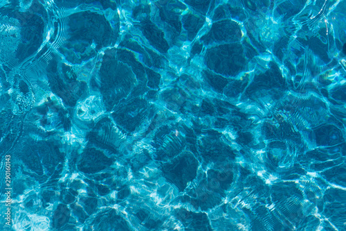 Light ripples on the surface of blue swimming pool water