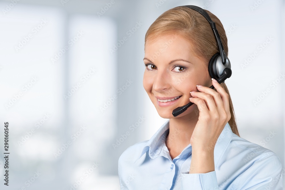 Close-up view of young woman face with headphones, call center or support concept Close-up view of young woman face with headphones, call center or support concept