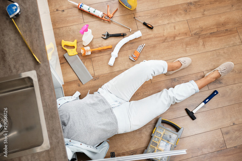 Photography Woman fixing kitchen sink