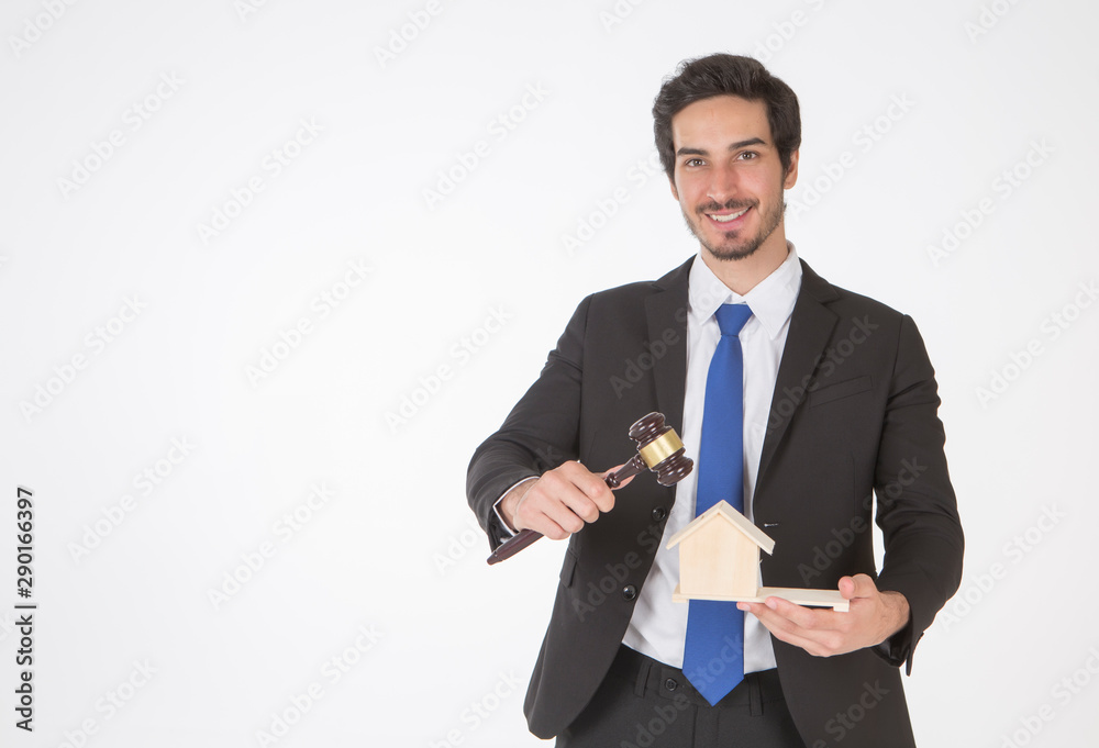 Auctioneer knocking down a property sale holding a model house as he holding gave in hand, or a lawyer or judge mediating in a property dispute in court white background. Auctioneer knocking down a property sale holding a model house as he holding gave in hand, or a lawyer or judge mediating in a property dispute in court white background.