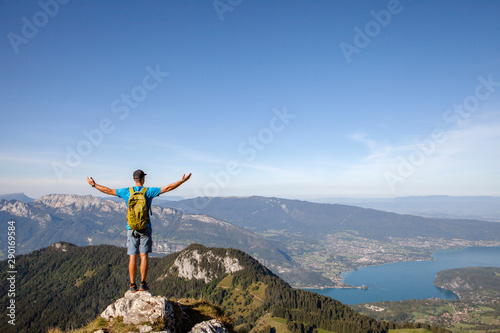 Happy hiker full of freedom and happiness, winning reaching life goal, achievement in mountains and success in life. Exploring new summits and adventures. La Tournette, Annecy, France