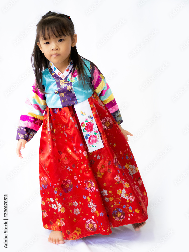 Asian little girl wearing a Korean Traditional Hanbok dress in white background Asian little girl wearing a Korean Traditional Hanbok dress in white background