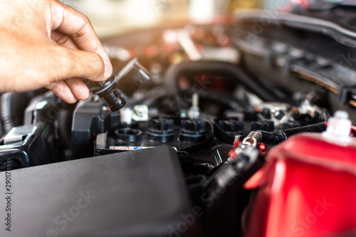 Man service mechanic maintenance inspection service maintenance car Check engine oil level car in garage showroom dealership blurred background.