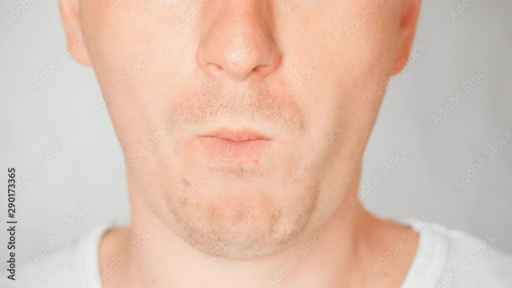 lower face caucasian male eats cookies cream portrait guy bites and chews lower face caucasian male eats cookies cream portrait guy bites and chews