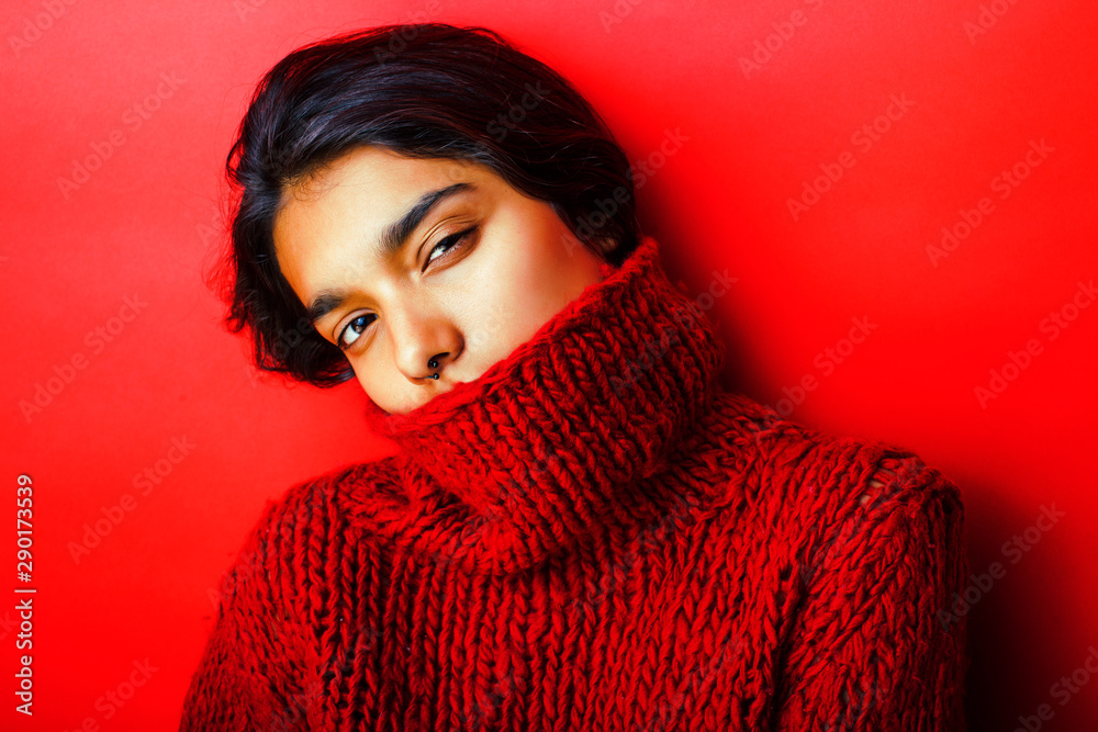 young pretty indian girl in red sweater posing emotional, fashion hipster teenage, lifestyle people concept close up