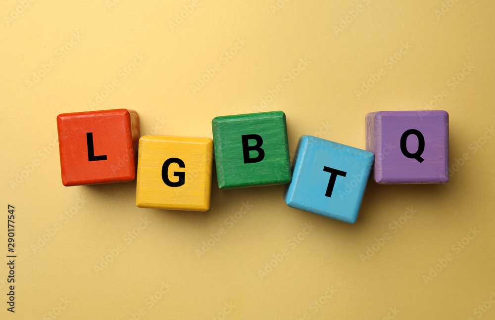 Obraz premium Cubes with abbreviation LGBTQ on color background