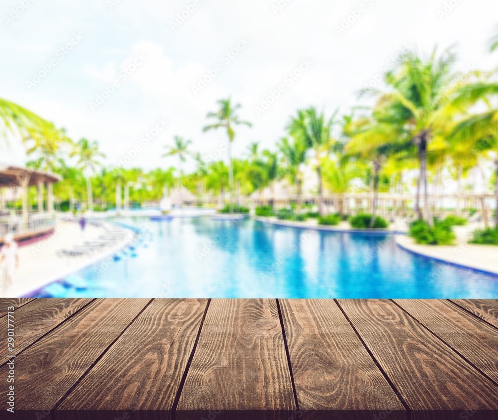 Fototapeta premium Pool to the Beach with Palms on background