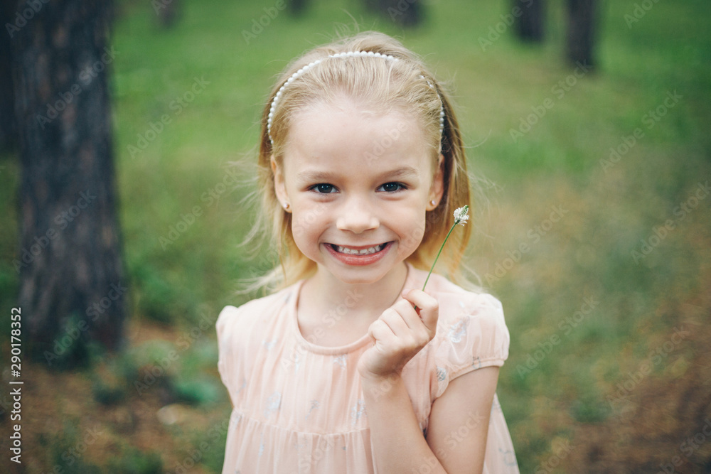 beautiful girl holding flowers. March 8: blonde among flowers. the concept of congratulations, women's holidays beautiful girl holding flowers. March 8: blonde among flowers. the concept of congratulations, women's holidays