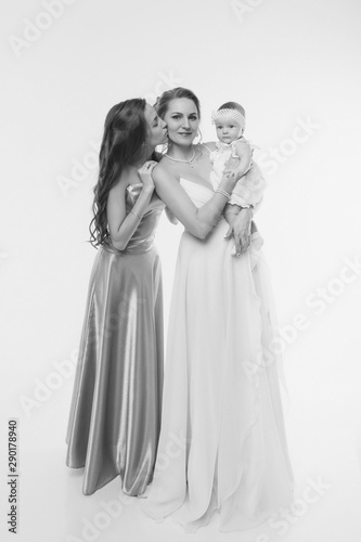 wedding fashion concept for women of all ages. A group of women in long evening dresses on a white background