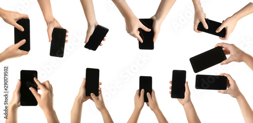Many female hands with modern smartphones on white background