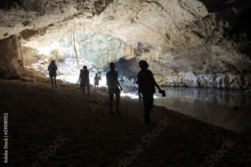 Silhouette of people hiking in underground cave © Rafael Ben-Ari
